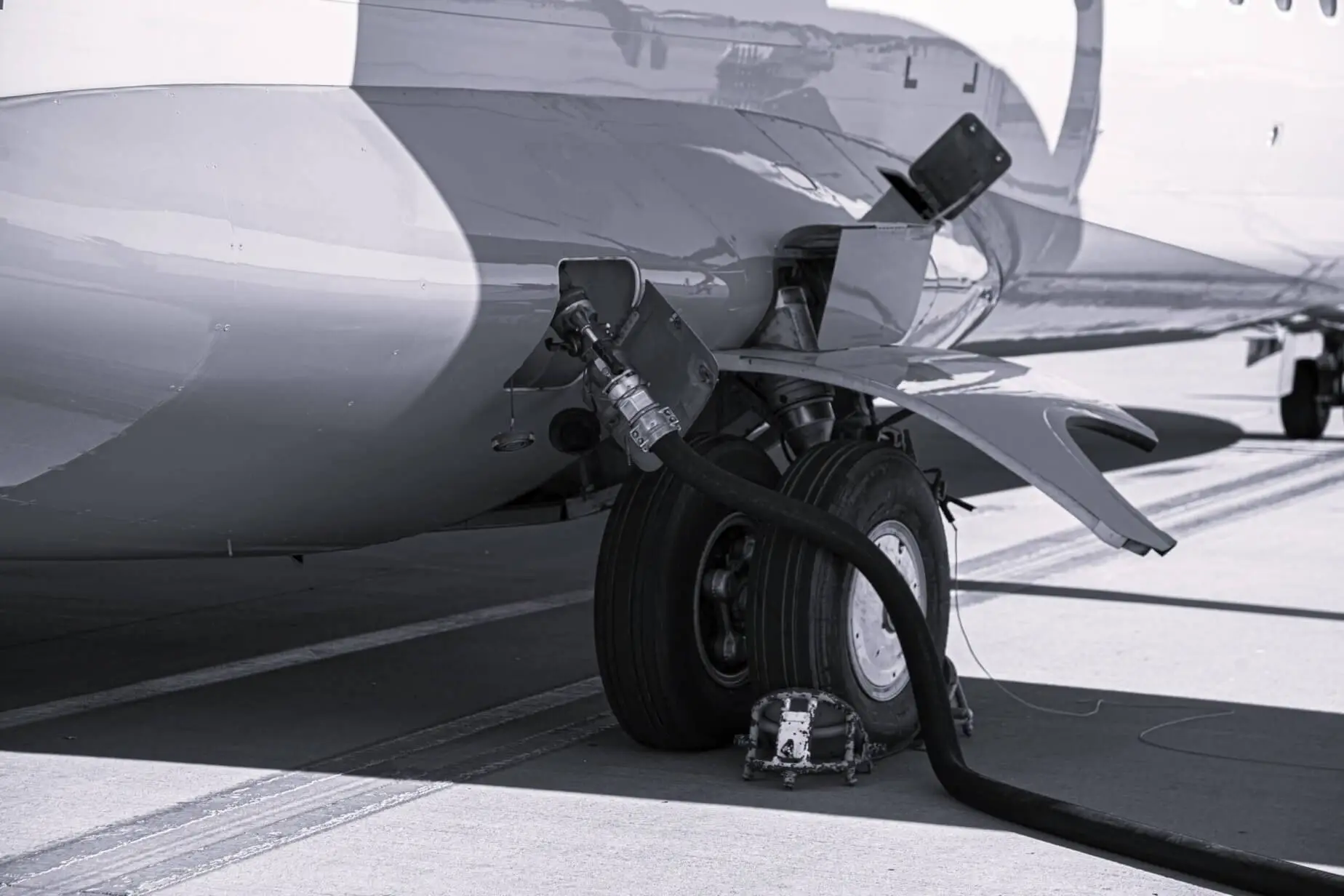 Refueling the plane Filling tank and gun Fuel supply through a hose - Fuel Logic aviation fuel