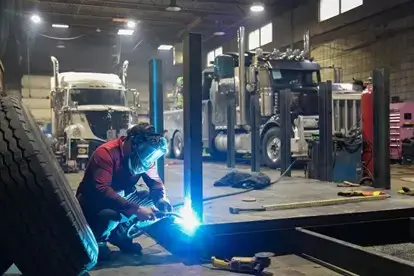 a specialized diesel mechanic fixing a runaway diesel engine in a repair shop