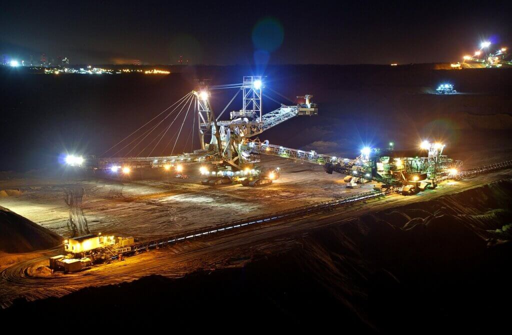 large scale industrial mining complex operating at night