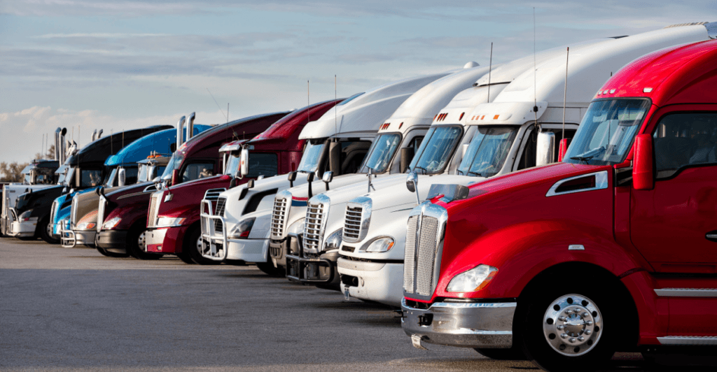 fleet trucks parked in a yard at dusk - Fuel Logic fleet trucks parked in a yard at dusk